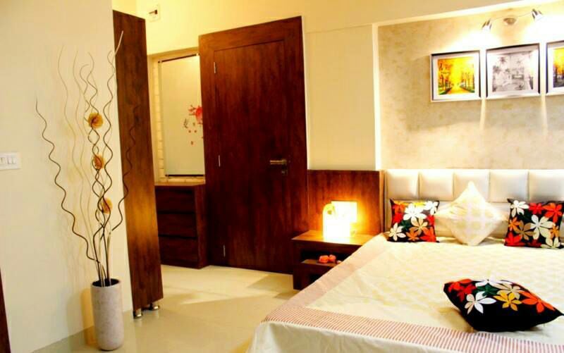 Bedroom With Golden Ambient light and White Headrest by Rupali Khoje Bedroom Modern | Interior Design Photos & Ideas