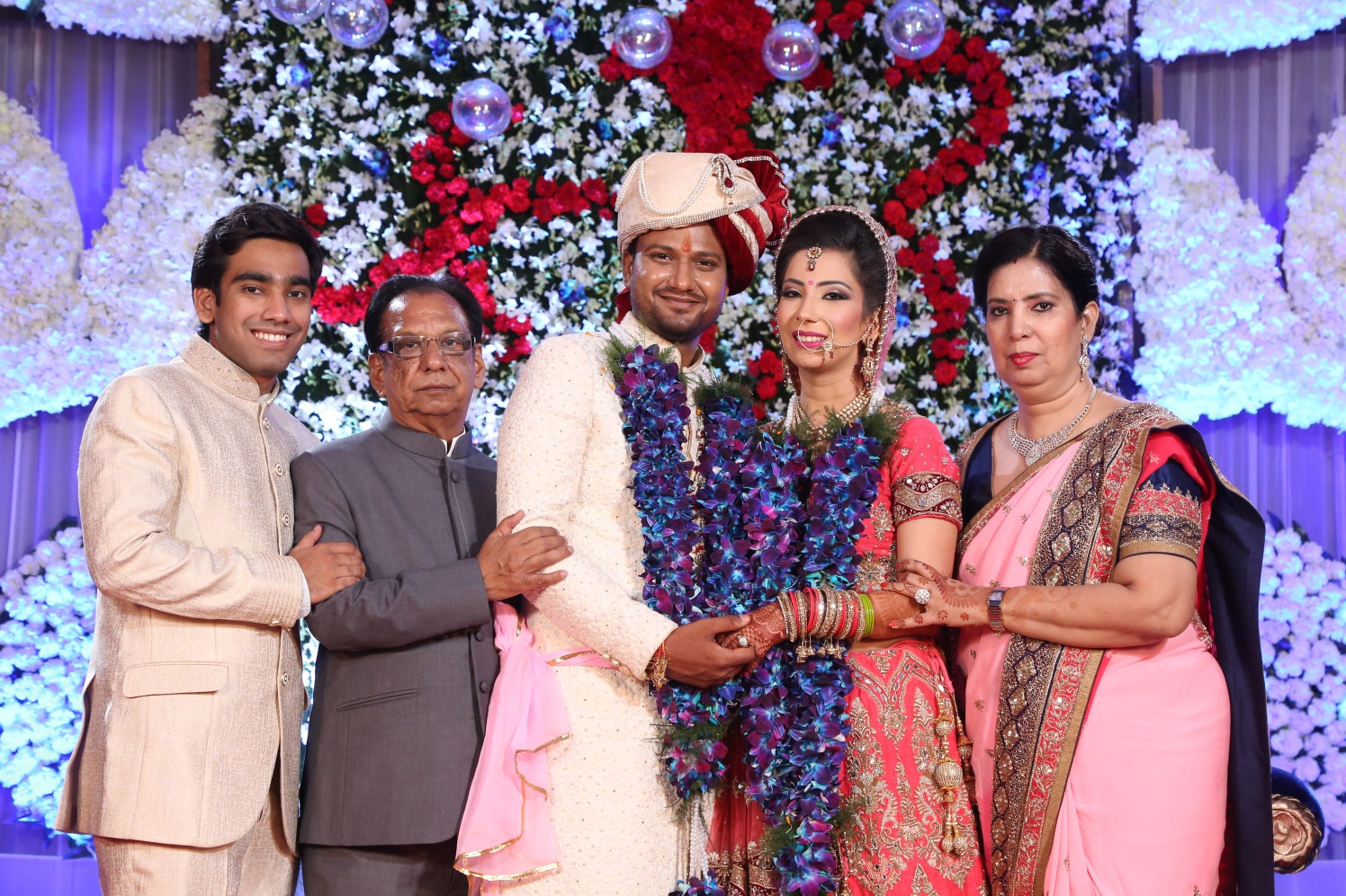 Bride and Groom Pose With Their Family During Their Wedding Day by Amit Kumar Wedding-photography | Weddings Photos & Ideas