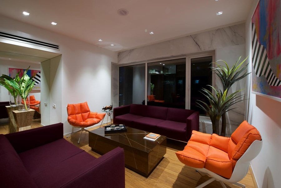 Lavishing living area with sofa and orange couch by Siraj Living-room Contemporary | Interior Design Photos & Ideas