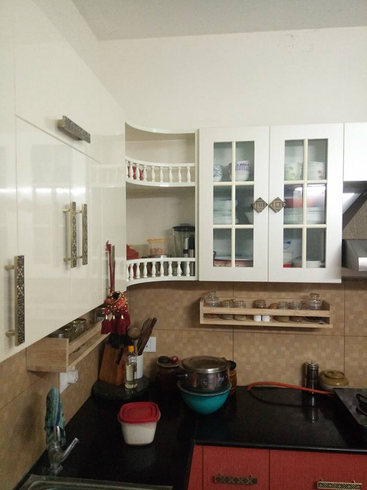 L shaped kitchen with white cabinets by Ganesh