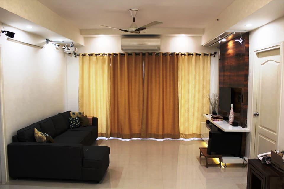 Living space with black sofa curtains and false ceiling by Ganesh Living-room Contemporary | Interior Design Photos & Ideas