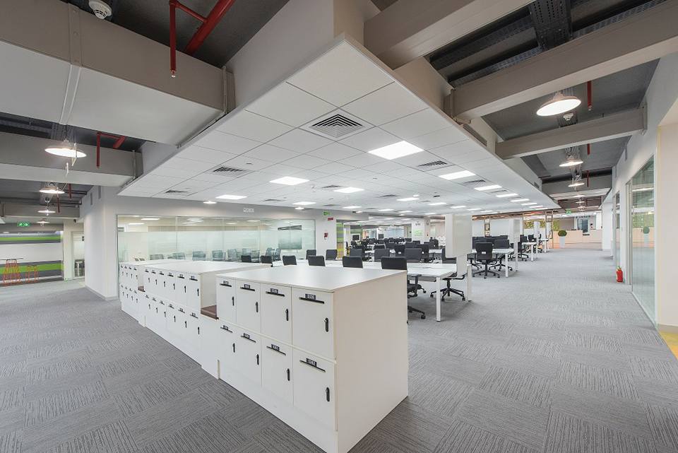 open office with white desk and black chairs by Ganesh Modern | Interior Design Photos & Ideas