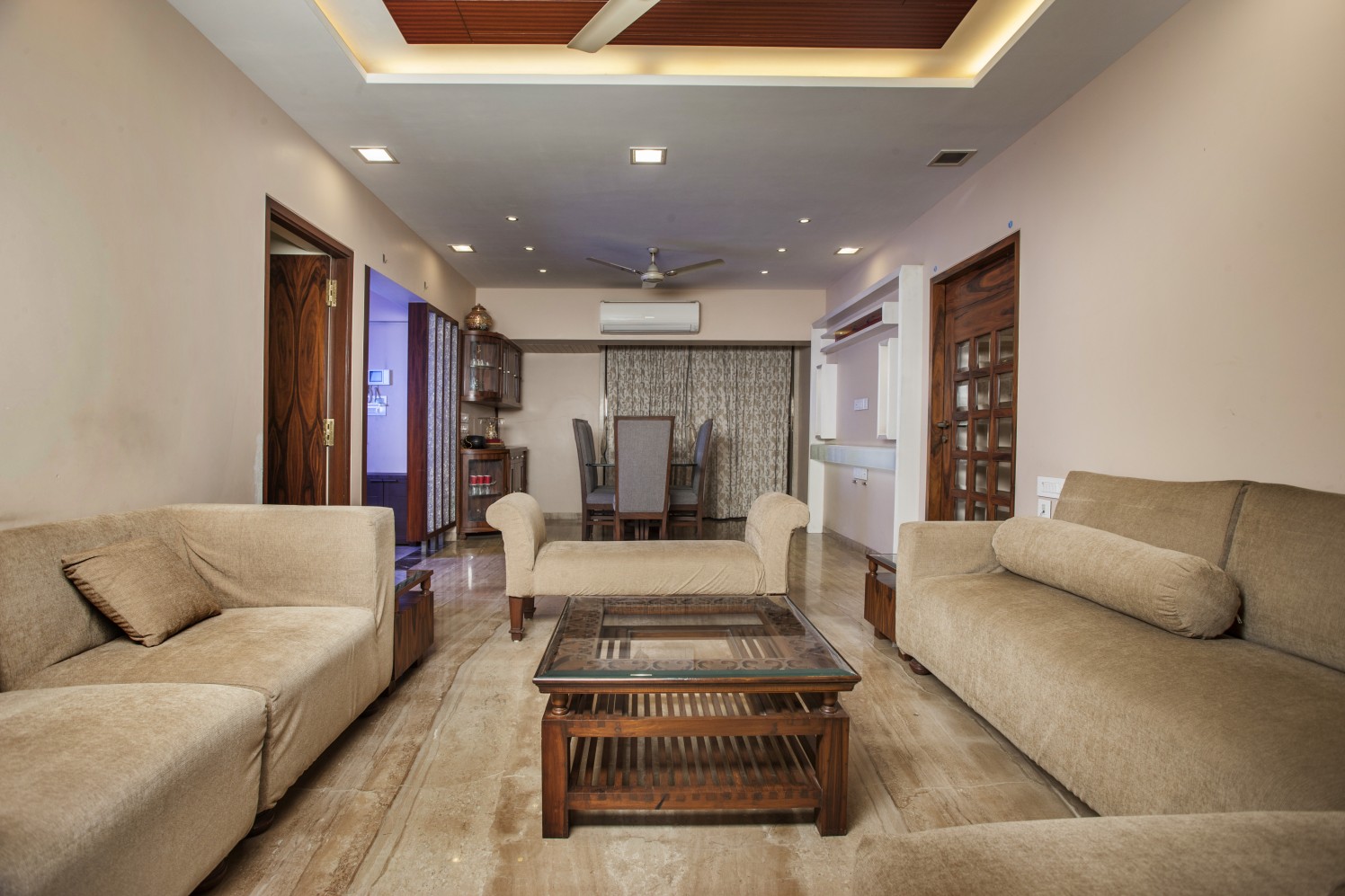 Beige Cushioned Sofas And Glass Top Wooden Table by Ravnit Kaur Sharma Living-room Contemporary | Interior Design Photos & Ideas