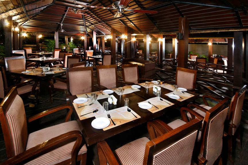 Sophisticated Restaurant with Wooden Table and Chair by Mayank Manchanda Contemporary | Interior Design Photos & Ideas