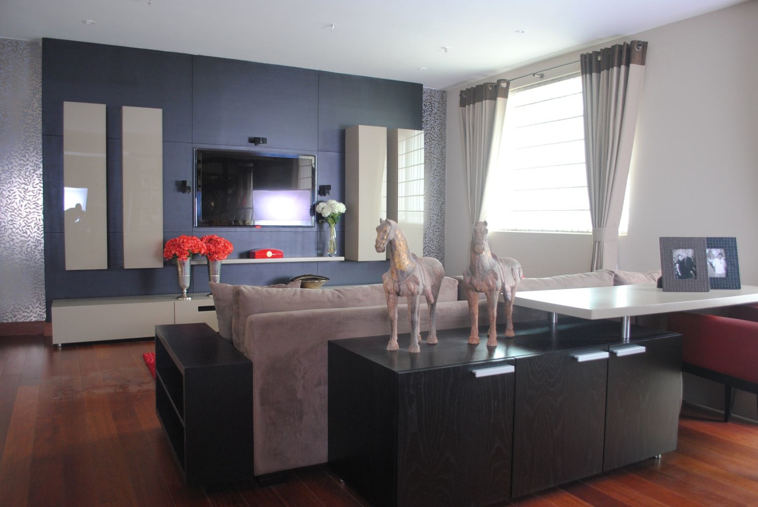 Elegant Living Room with Blue Wall and Wooden Flooring by Mayank Manchanda