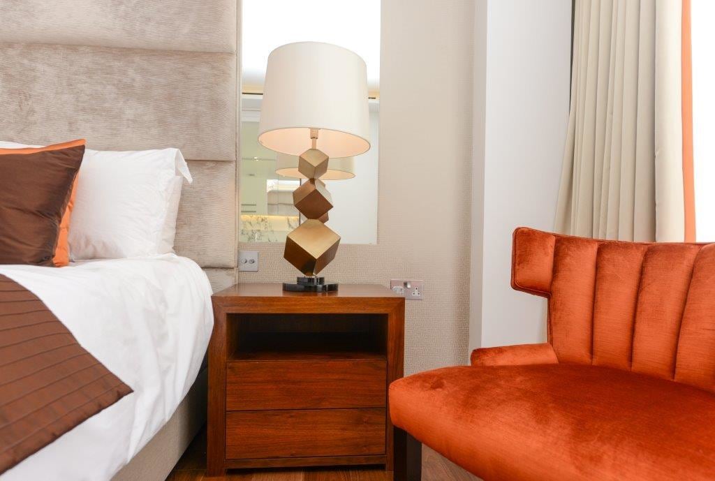 Wooden Nightstand with Edgy Lamp and Brown Chair by Mayank Manchanda Bedroom Contemporary | Interior Design Photos & Ideas