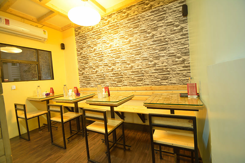 Compact Cafe with Wood Finished Table and Chair by Jayant Arwat Modern | Interior Design Photos & Ideas