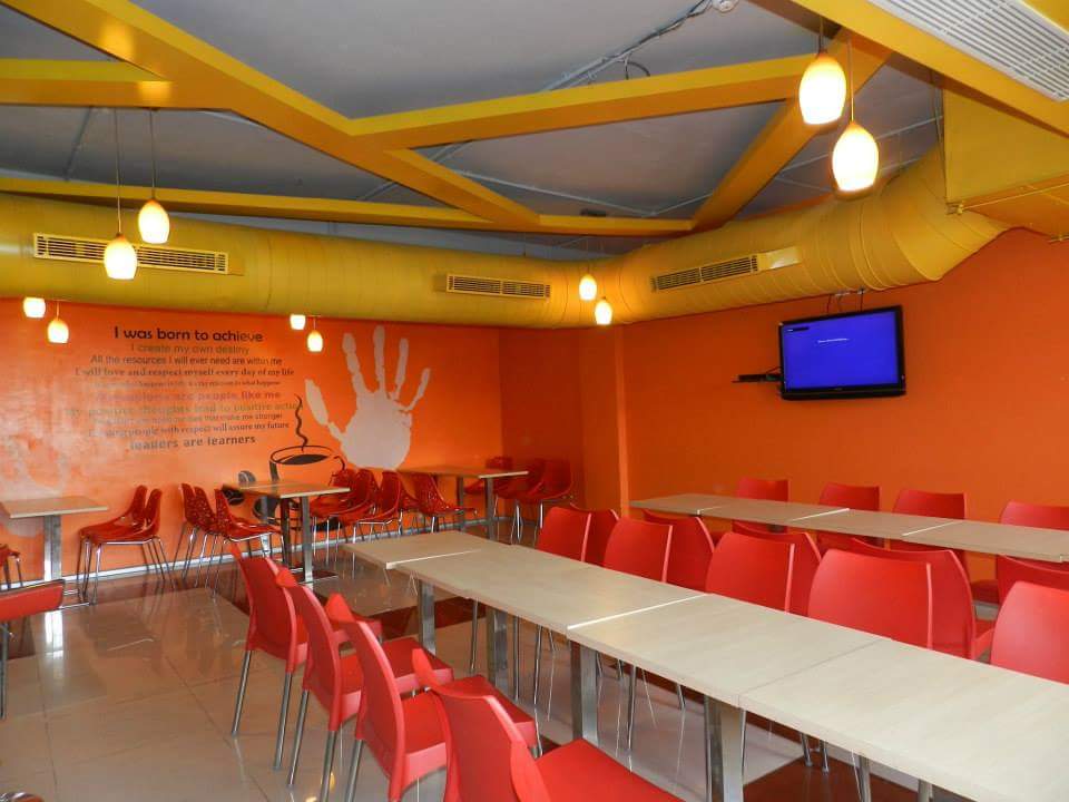 The red and yellow dining space by Sukriti Architecture & Interiors