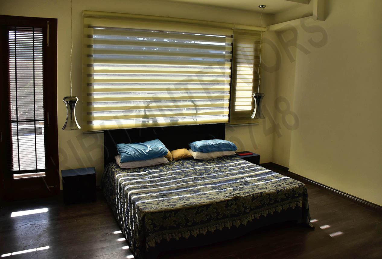 Green Bedroom With Black Wooden Bed And Wooden Floor by Tribuz Interiors Pvt. Ltd. Bedroom Contemporary | Interior Design Photos & Ideas