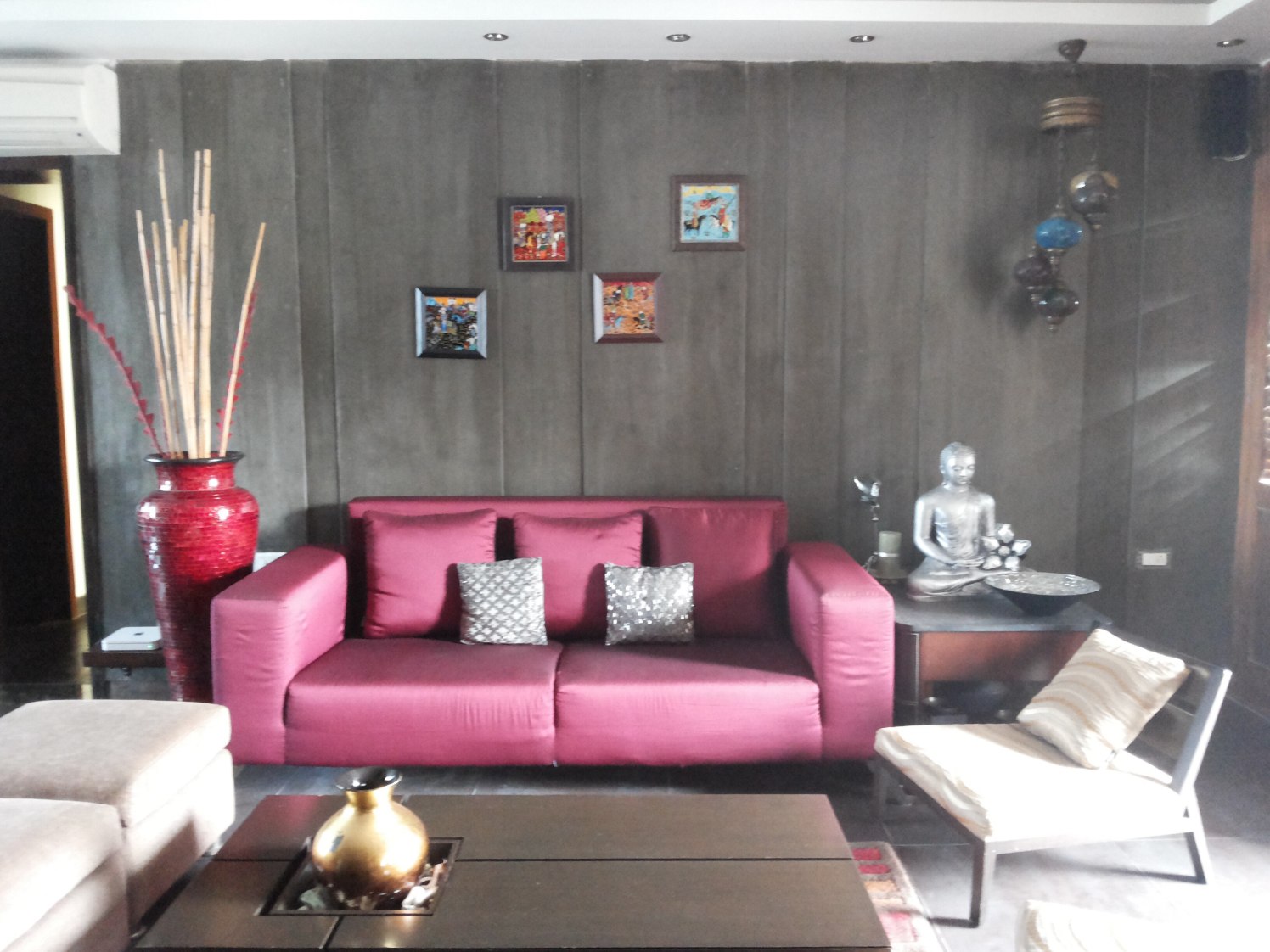 Living space with wooden wall decor and pink sofa by Milind Kapadia Living-room Modern | Interior Design Photos & Ideas