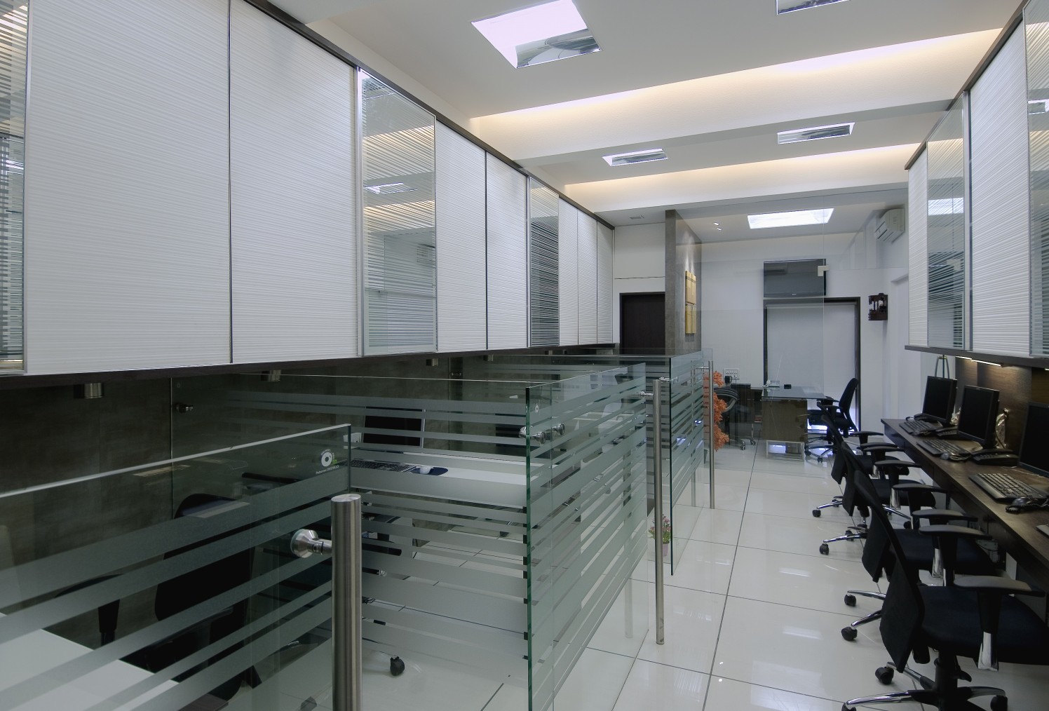 Open Office Space with black chairs and wooden desk by Milind Kapadia Modern | Interior Design Photos & Ideas