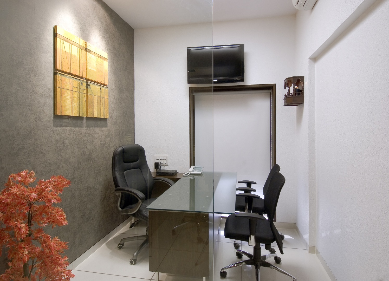 Cellular office with black chairs and tv unit by Milind Kapadia Contemporary | Interior Design Photos & Ideas