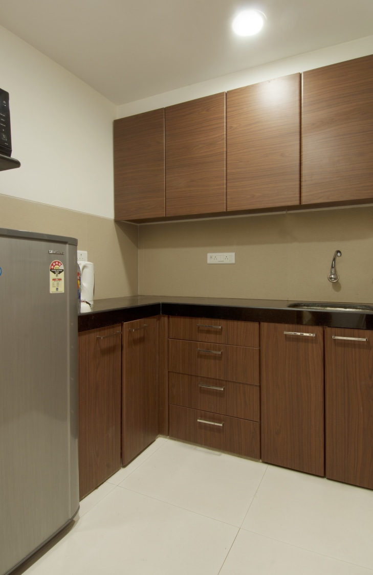 L shaped kitchen with wooden cabinets by Milind Kapadia Modular-kitchen Contemporary | Interior Design Photos & Ideas