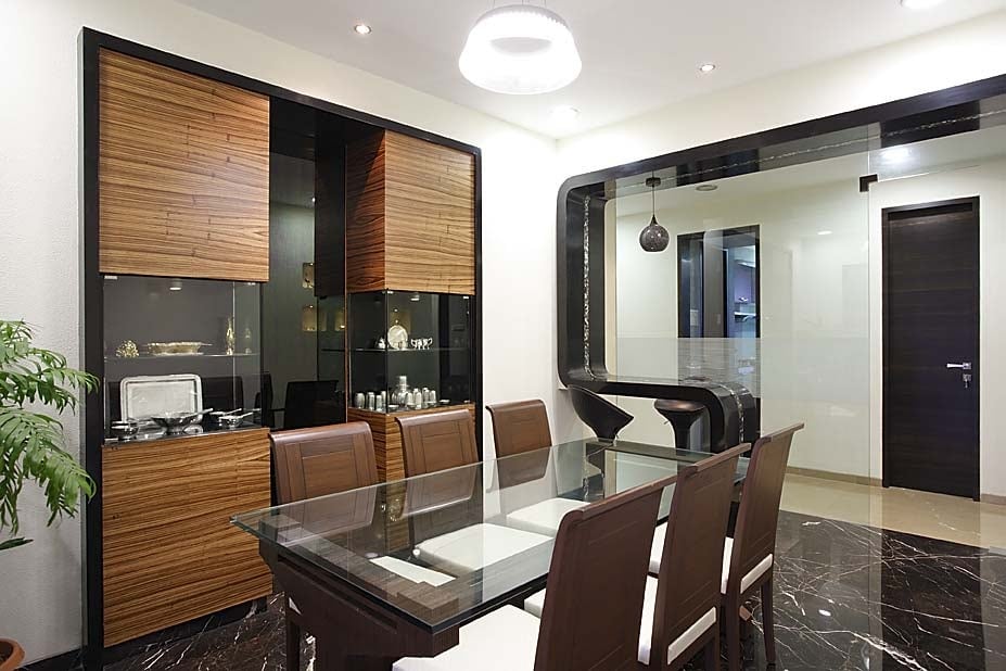 Dinning space with brown furniture and wooden display unit by Milind Kapadia Dining-room Modern | Interior Design Photos & Ideas