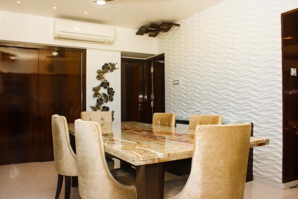 Textured White Wall And Polished Marble Dining Table In Modern Dining Room by VERSATILE INTERIORS Dining-room Eclectic | Interior Design Photos & Ideas