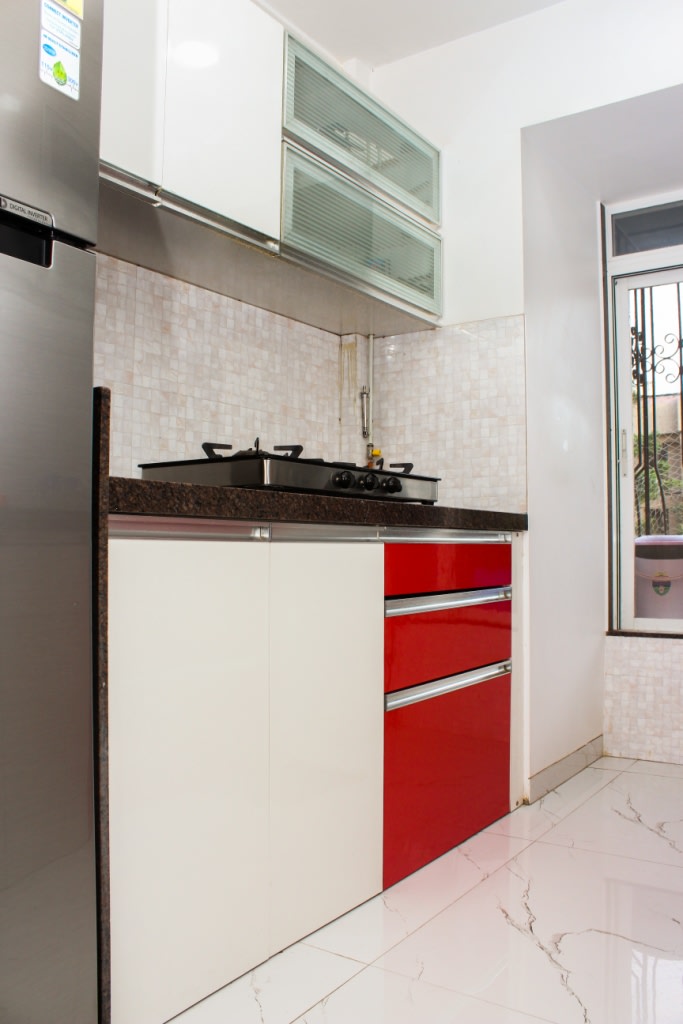 White And Red Wooden Cabinets And Marble Flooring by VERSATILE INTERIORS Modular-kitchen Modern | Interior Design Photos & Ideas