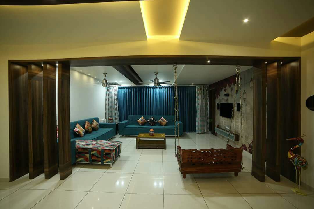 Spacious Living space with marble flooring and false ceiling with blue sofa and colored cushions by Chandni Goel Living-room Contemporary | Interior Design Photos & Ideas