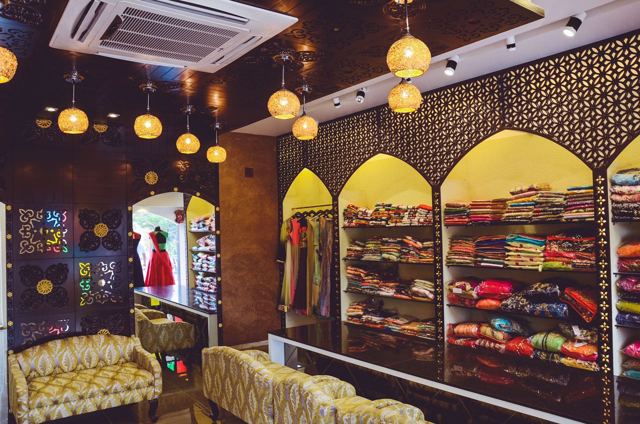 Showroom With Wooden Intricate Work by Nirav Gor Minimalistic | Interior Design Photos & Ideas