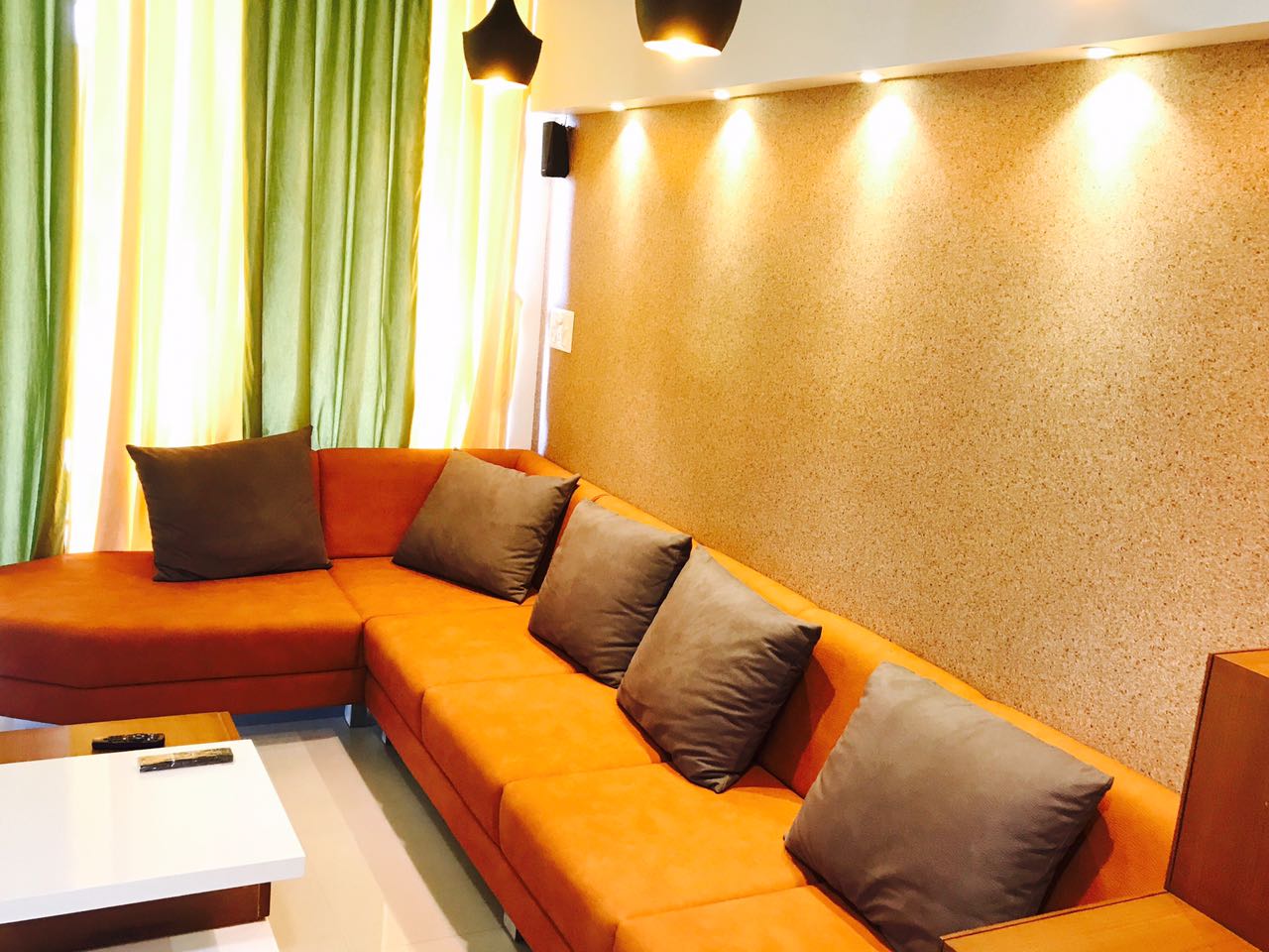 Orange Sectional Sofa With Brown Cushions And Pendant Lights by Nirav Gor Living-room Contemporary | Interior Design Photos & Ideas