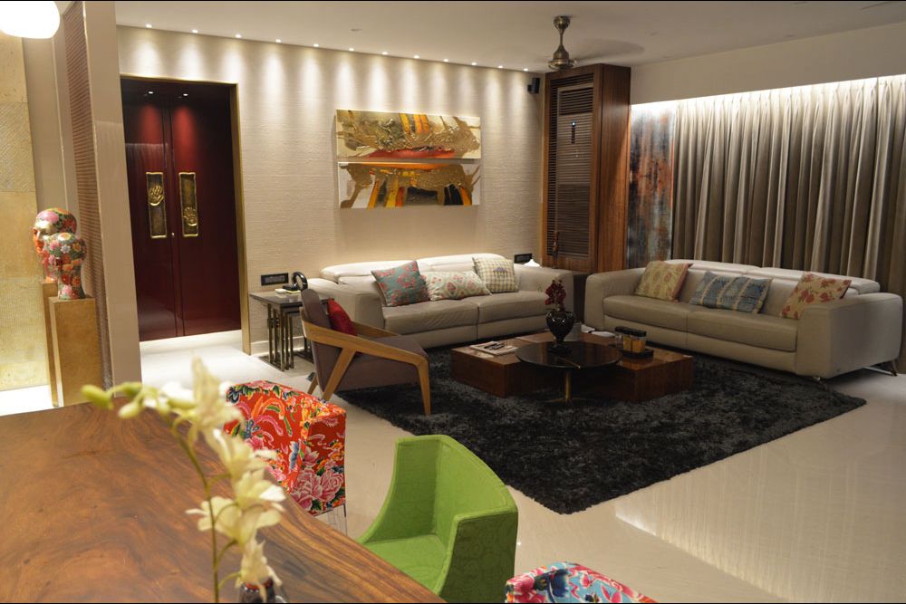 Living room with sectional grey sofas and circular glass top center table by Gocosy.com Living-room Eclectic | Interior Design Photos & Ideas