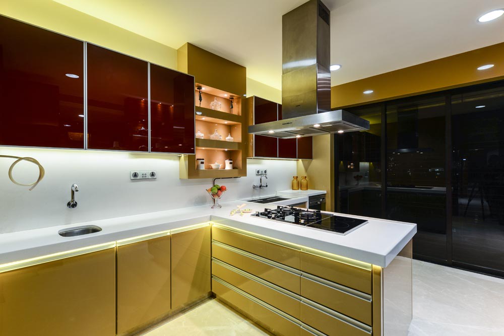L shaped kitchen with white counter top and golden base and wall cabinets by Gocosy.com Modular-kitchen Modern | Interior Design Photos & Ideas