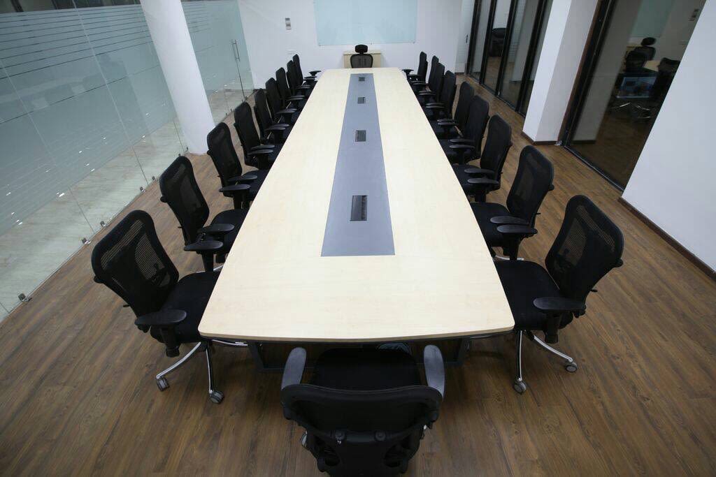 Meeting Room With Black Chairs And White Wooden Table by Rimpy Shah Contemporary | Interior Design Photos & Ideas