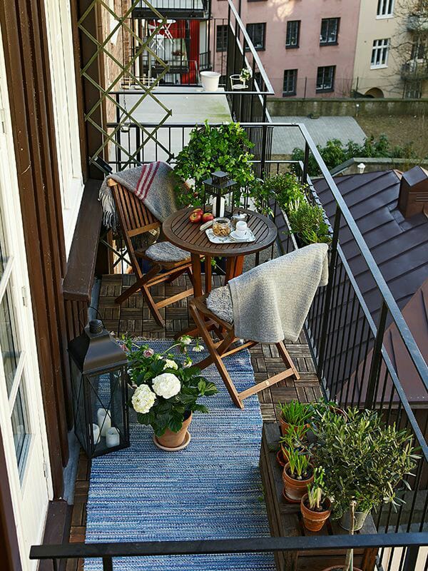 Vintage Balcony With Traditional Wooden Chairs And Blue Rug by Live Fabulous Open-spaces Modern | Interior Design Photos & Ideas