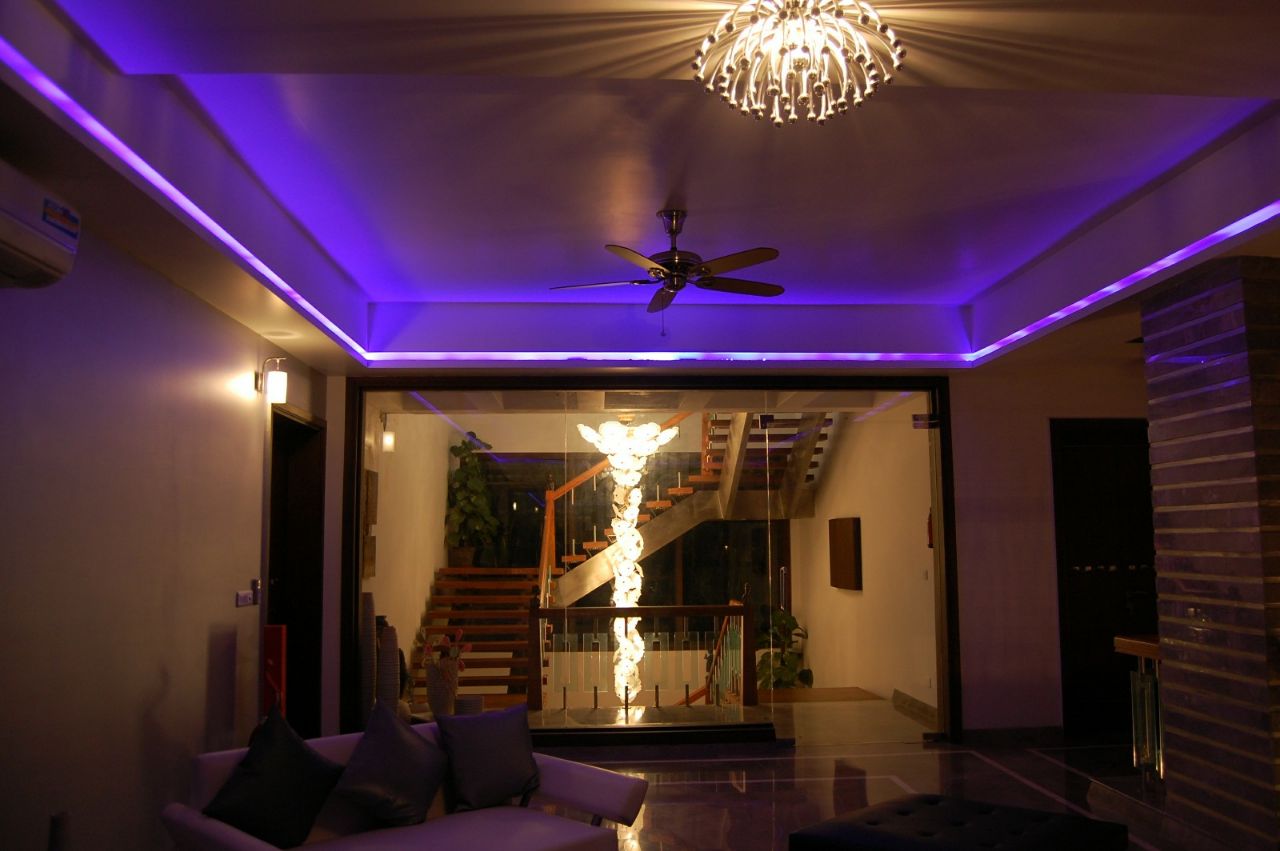 Living Room With Blue Ceiling Lighting and Crystal Chandelier by Madhu Kailashi Contemporary | Interior Design Photos & Ideas