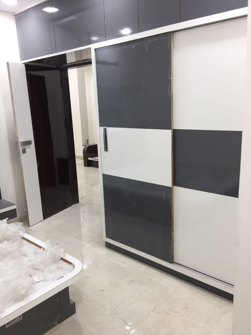 Wardrobe With White and Walnut Brown Shaded Sliding Door by Shravan Hendre Bedroom Modern | Interior Design Photos & Ideas