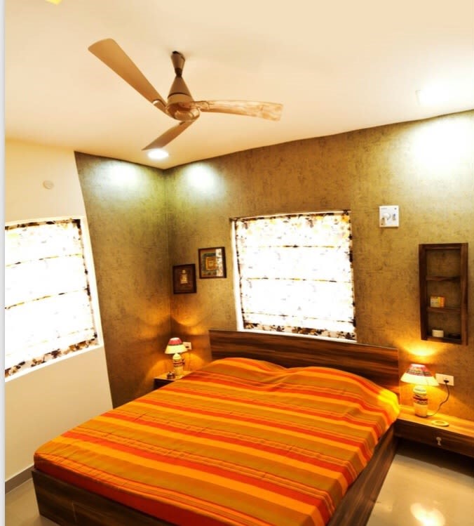 Saffron and orange themed bedroom with golden wallpaper by Sarath Sasi P Bedroom Contemporary | Interior Design Photos & Ideas