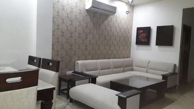 L-Shaped Sectional Sofa And Wall Art In Living Room by Ashish Singh Living-room Contemporary | Interior Design Photos & Ideas