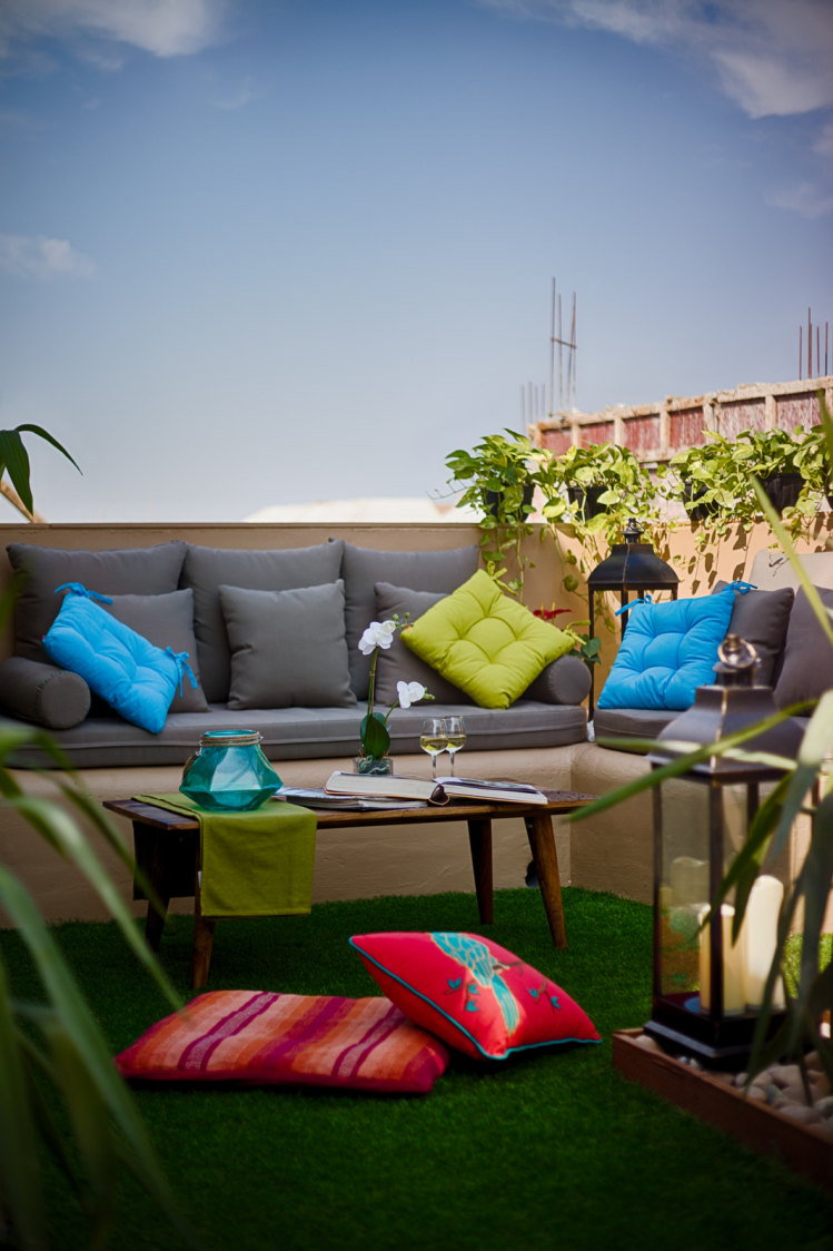 Grey Couch with Colorful Cushions and Synthetic Turf on Floor by Dhaval Patel Open-spaces Contemporary | Interior Design Photos & Ideas