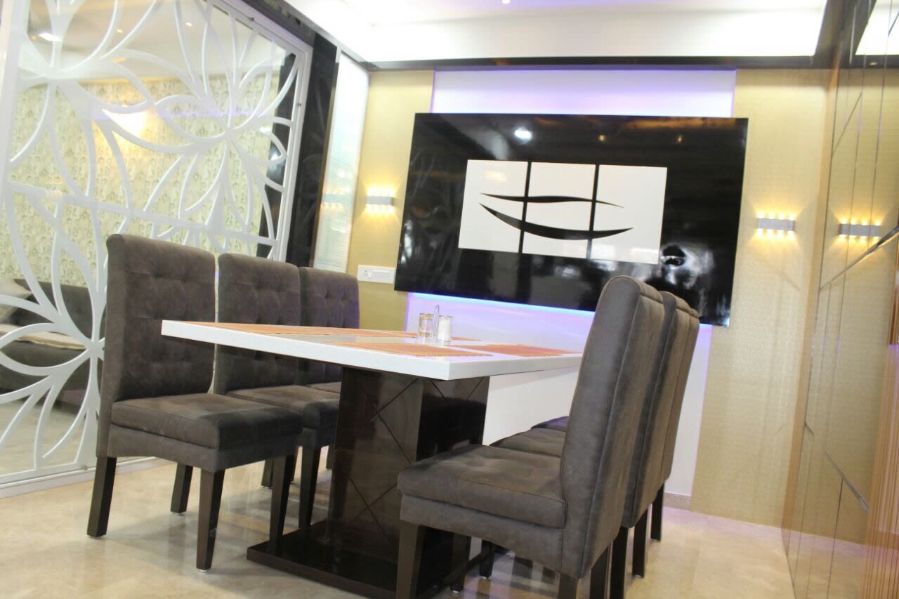 Dining Area With Sleek Wooden Table And Marble Flooring by Jaldeep patel Dining-room Contemporary | Interior Design Photos & Ideas
