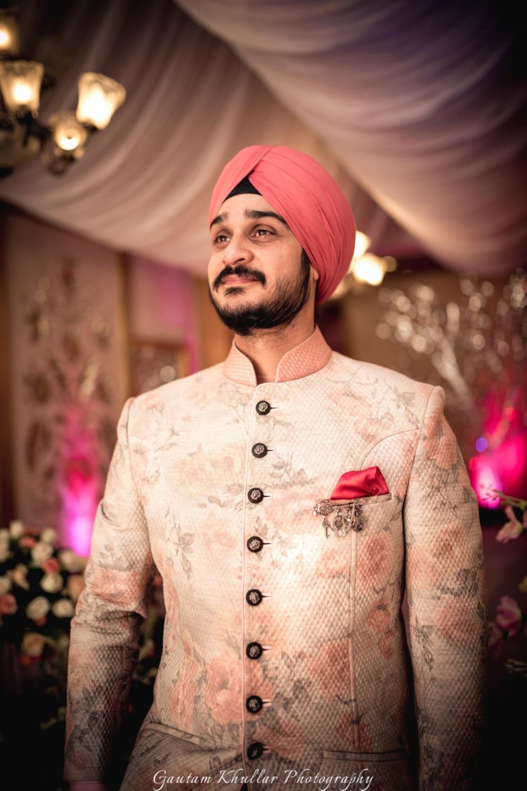 Soft Pink Flower Printed High Collared Sherwani With Black Circular Buttons And Pink Pocket Square by Gautam Khullar Groom-wear-and-accessories | Weddings Photos & Ideas