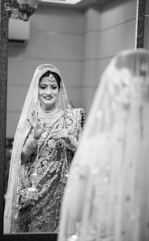 Admiring her bridal look by Captured Memories Wedding-photography | Weddings Photos & Ideas