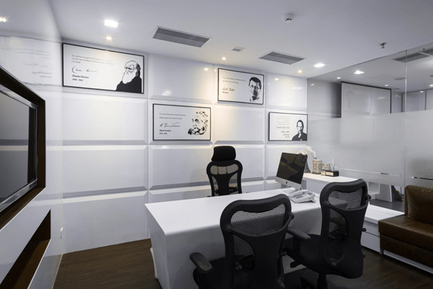 An office cabin with wooden flooring and white background by Every Inch Modern | Interior Design Photos & Ideas