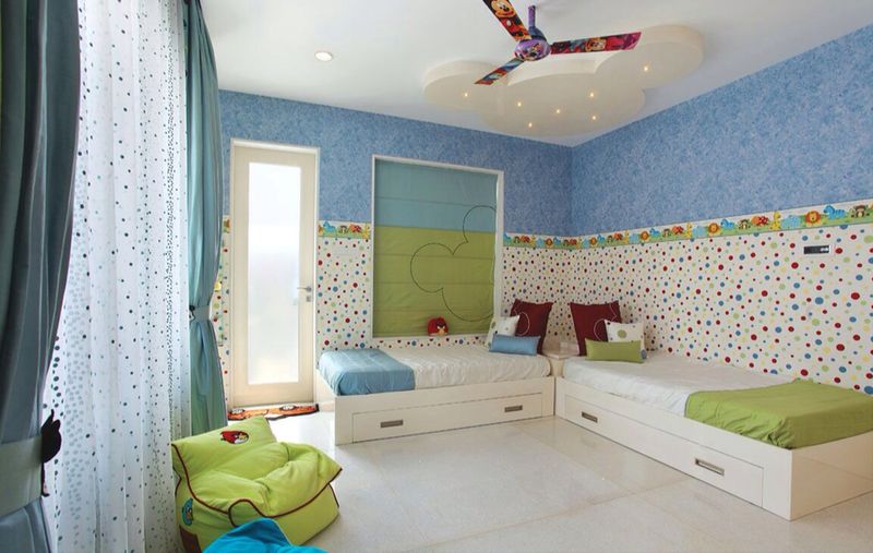 Vibrant kid's bedroom with two single bed and Mickey shaped false ceiling by R. Gautam Jain Bedroom Modern | Interior Design Photos & Ideas