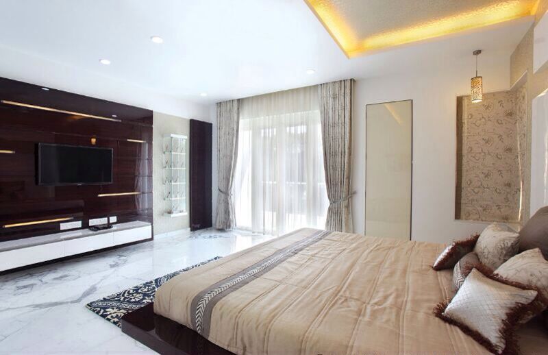 Spacious Bedroom With Dark Wooden Television Cabinet by R. Gautam Jain Bedroom Contemporary | Interior Design Photos & Ideas