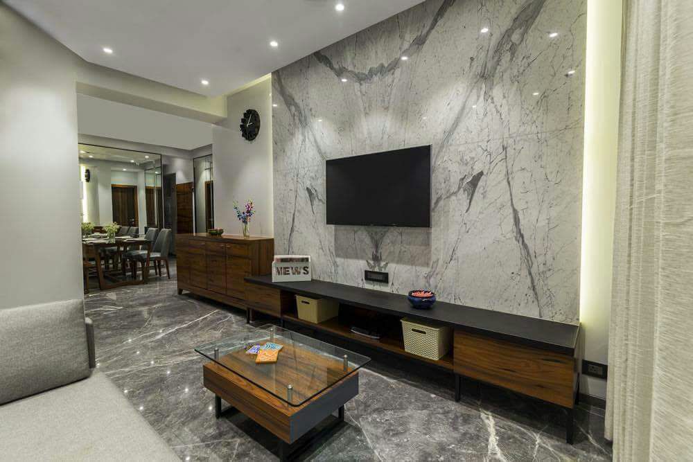 Glass Top Wooden Center Table And Marble Wall In Living Space by DD Jour Living-room Modern | Interior Design Photos & Ideas