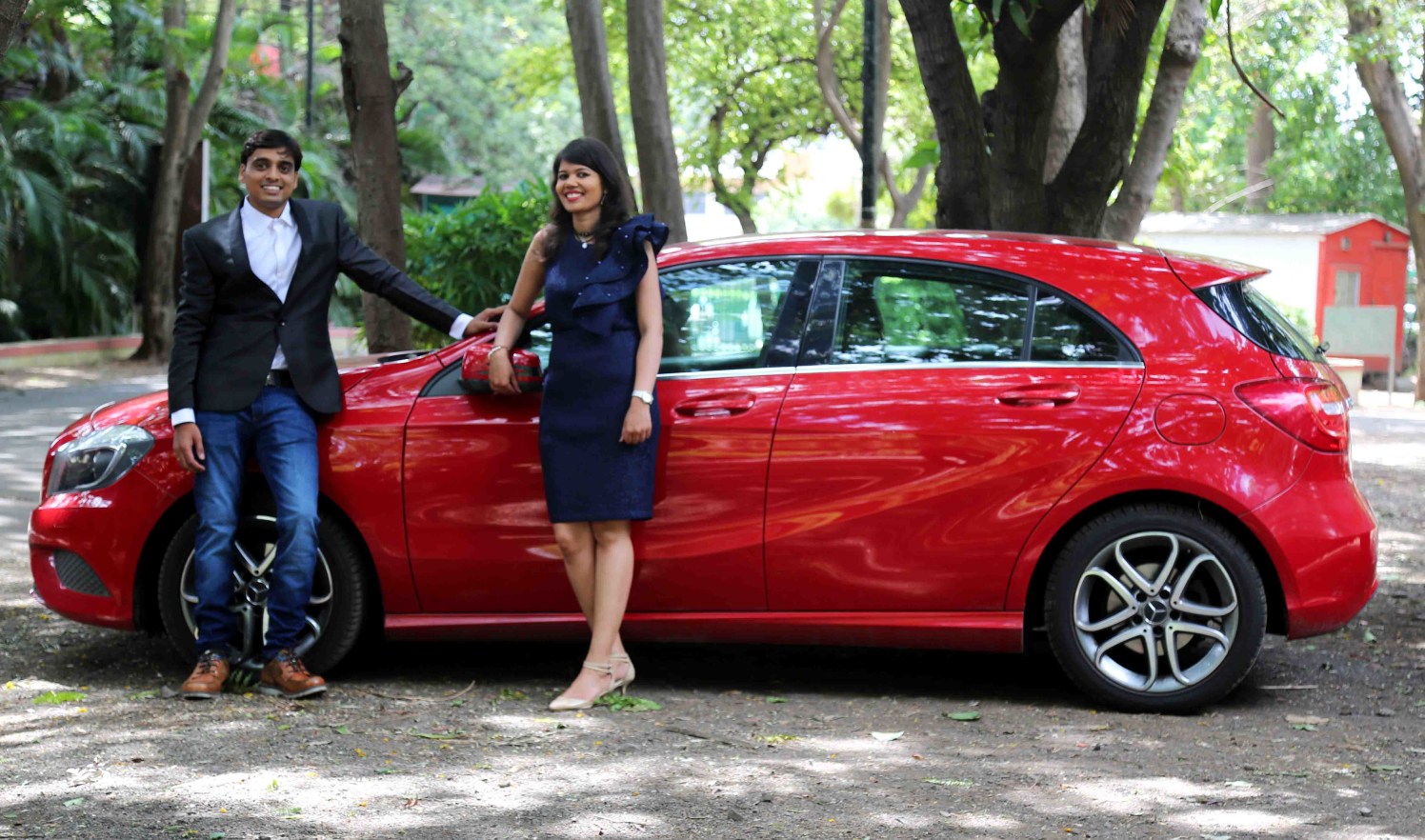 Bride and Groom To-Be Pose Against a Swanky Red Car by Rushil Jadhav Wedding-photography | Weddings Photos & Ideas