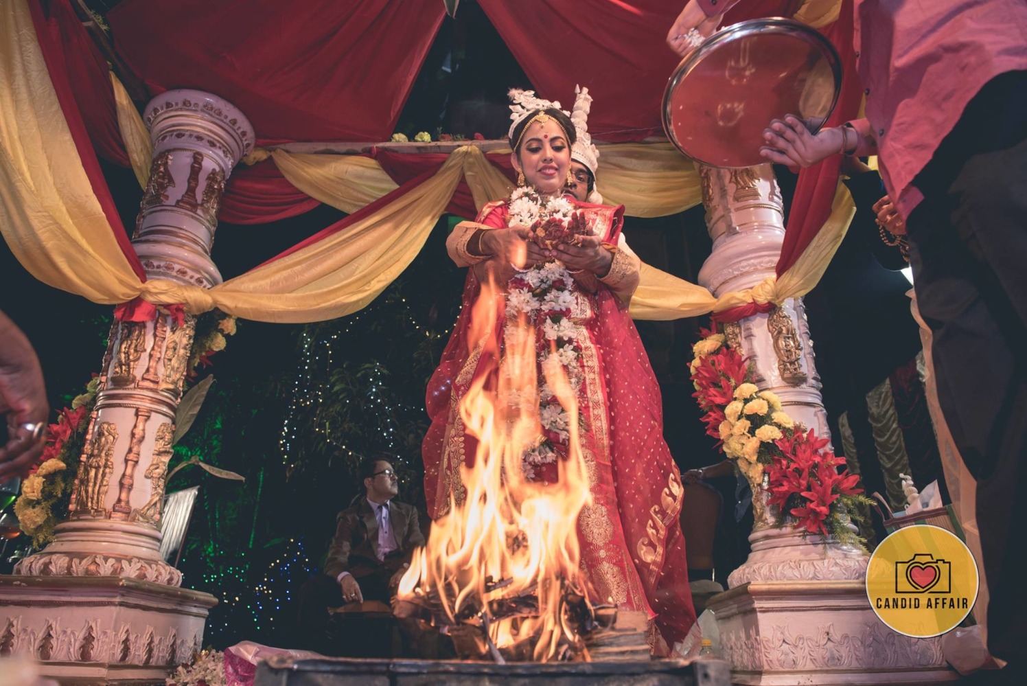 A Stunning Shot Of The Couple Performing Wedding Ritual by Candid Affair Wedding-photography | Weddings Photos & Ideas