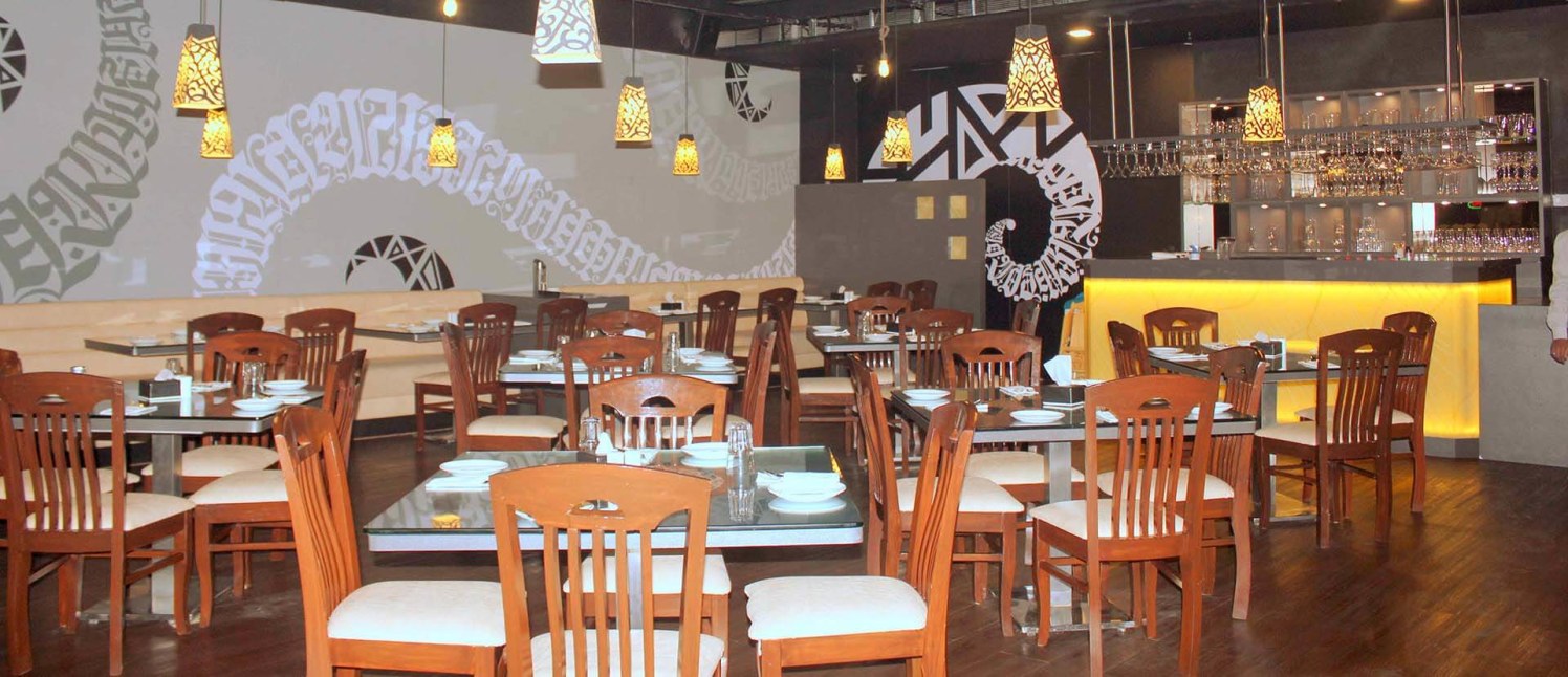 Restaurant Cum Bar with hanging Lamps and Wooden Flooring by Trupti Ladda Contemporary | Interior Design Photos & Ideas