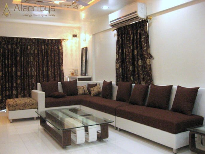 L - Shaped Sofa with Brown Cushions and Glass Top Centre Table by Trupti Ladda Living-room Modern | Interior Design Photos & Ideas