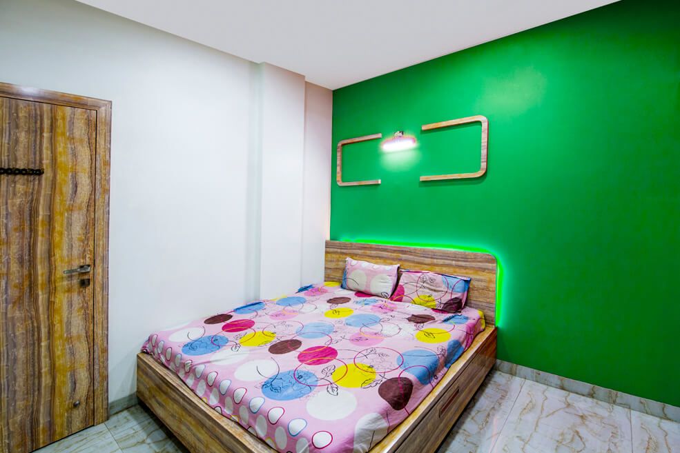 Wood Finished Queen Size Bed with Green Wall and Marble Flooring by Trupti Ladda Bedroom Minimalistic | Interior Design Photos & Ideas