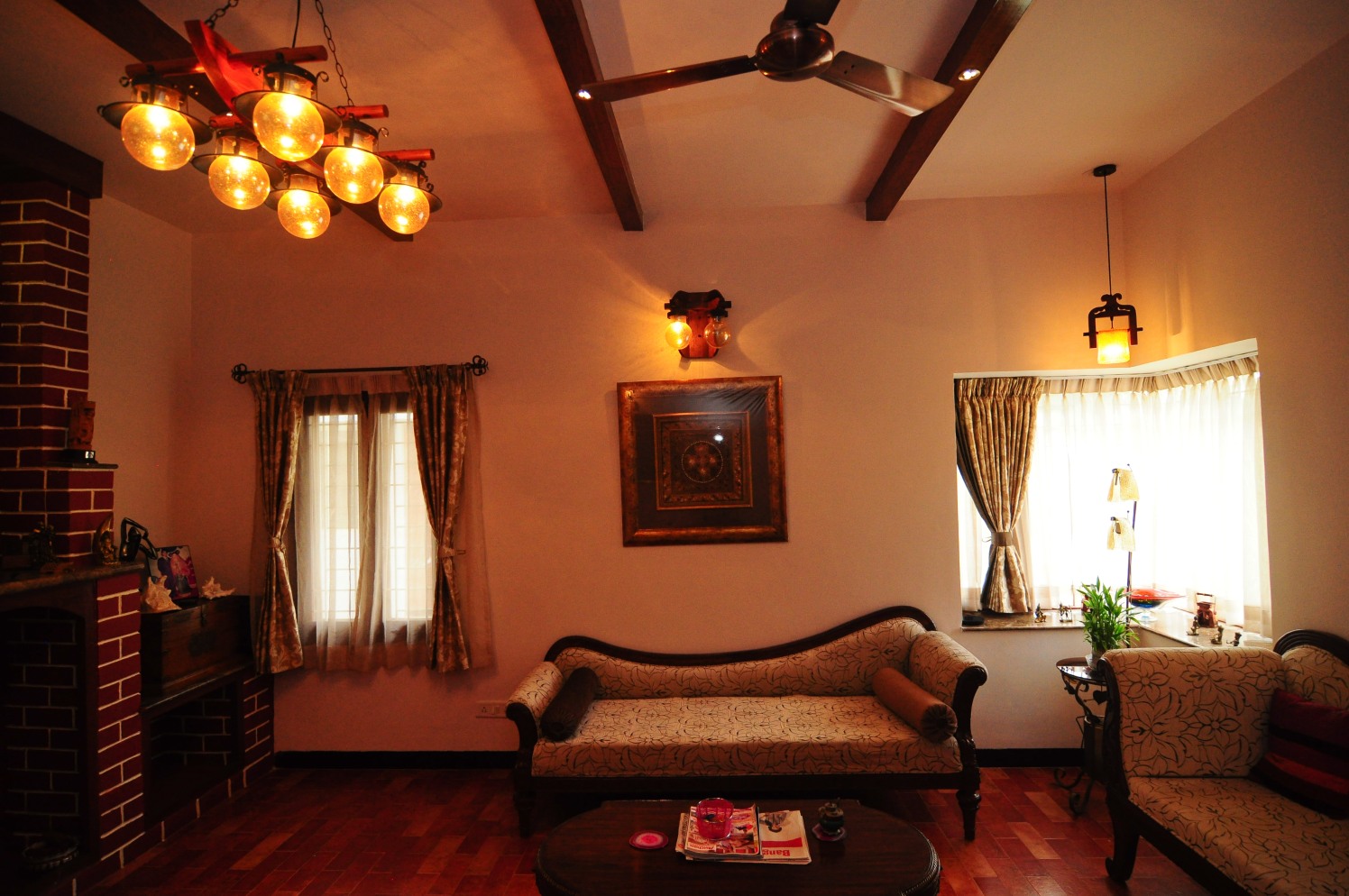 Wooden Camel Back Sofa and Wall Art with Bulb Designed Chandelier by Manasa Bharadwaj Living-room Vintage | Interior Design Photos & Ideas