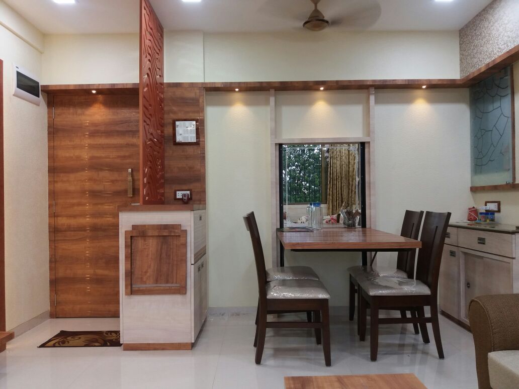 Dinning space with wooden designed furniture and wall decor by Nidhi Rathod Dining-room Modern | Interior Design Photos & Ideas