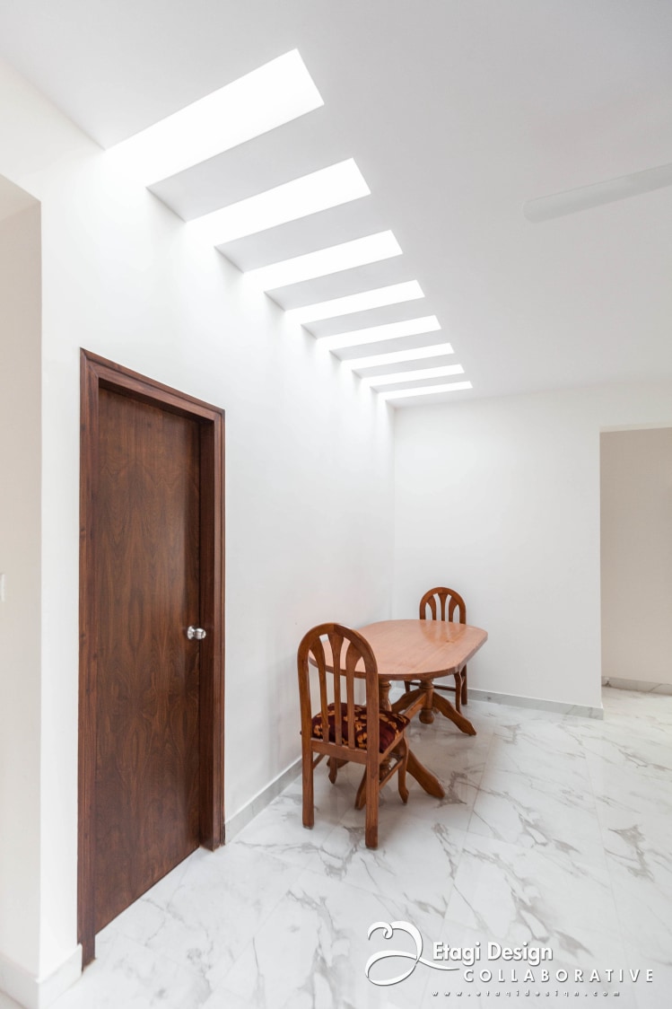 Wooden Dining Table With White Marble Flooring In Dining Room by Prashanth Nandiprasad Dining-room Contemporary Minimalistic | Interior Design Photos & Ideas