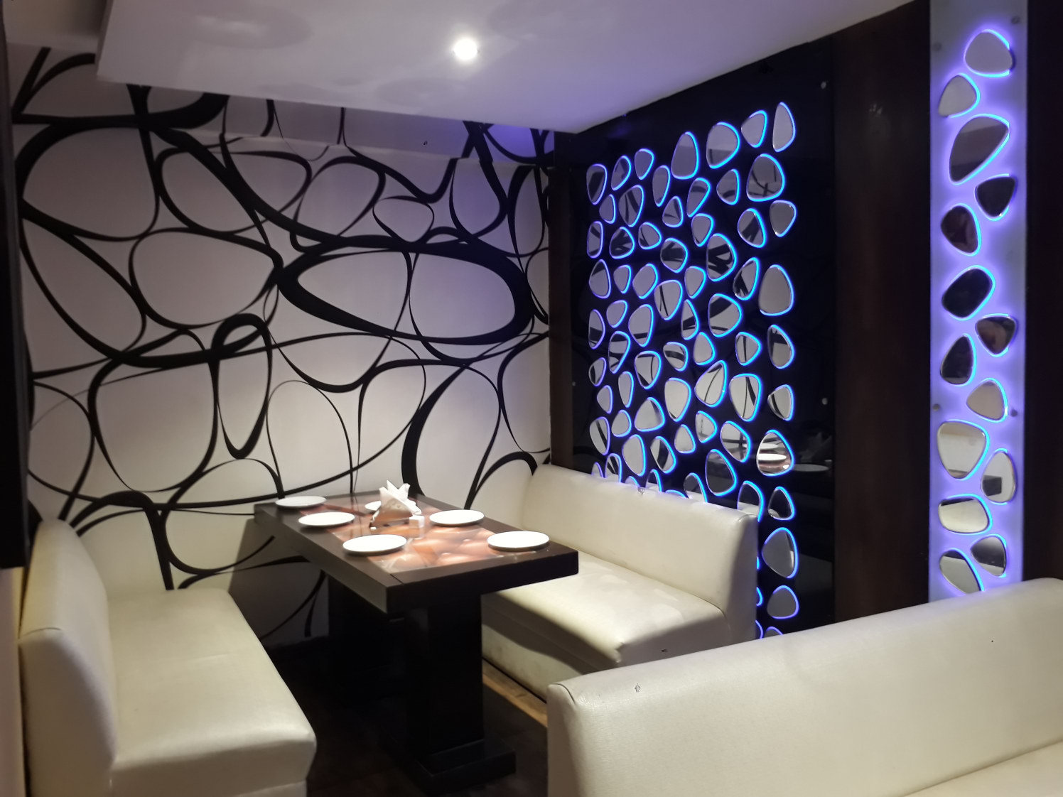 Stylish Restaurant with Designer Walls and White Sofas by Shailash Pandita Modern | Interior Design Photos & Ideas