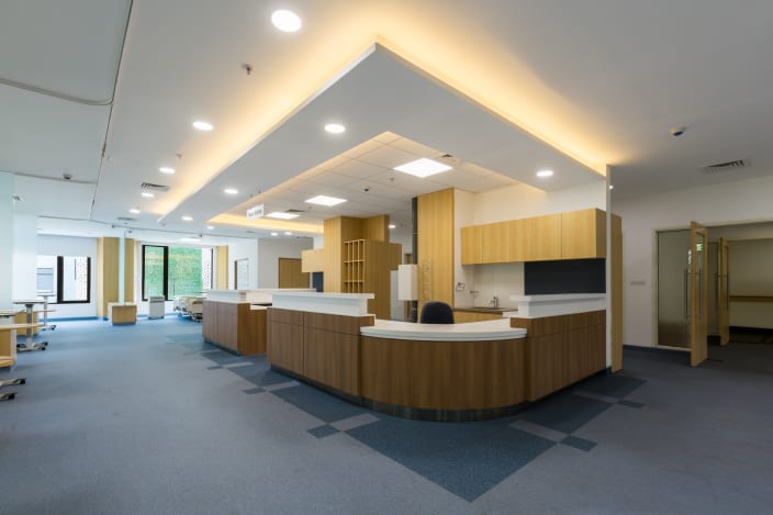 Hospital Reception With Wooden Desk And False Ceiling By