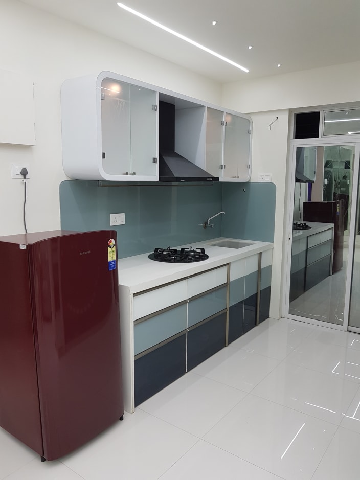 Elegant Modular Kitchen with White Counter Top and Blue 